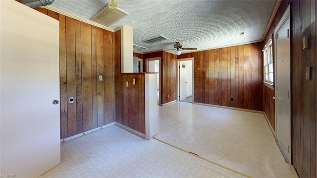 3702 Nansemond Pkwy, Suffolk, VA 23435 - empty room featuring baseboards, wood walls, ceiling fan, and a textured ceiling