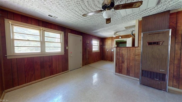 3702 Nansemond Pkwy, Suffolk, VA 23435 - entrance foyer featuring ceiling fan, wooden walls, an ornate ceiling, and baseboards