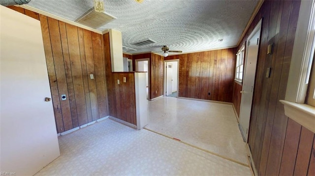 3702 Nansemond Pkwy, Suffolk, VA 23435 - hallway with light flooring, wooden walls, baseboards, and a textured ceiling