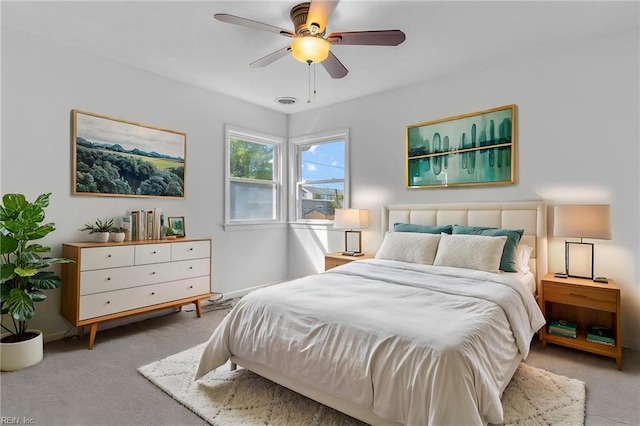 carpeted bedroom featuring a ceiling fan and baseboards