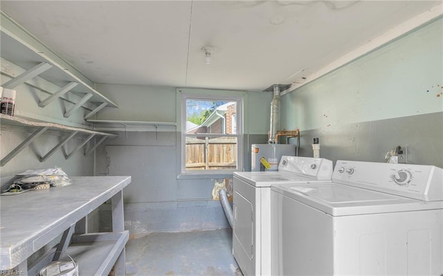 laundry area featuring laundry area, washer and clothes dryer, and water heater