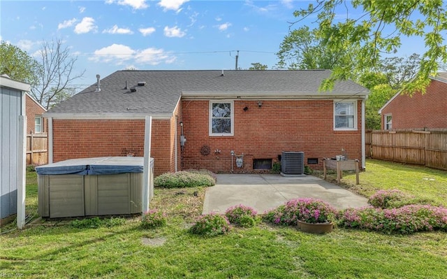 back of property featuring brick siding, a fenced backyard, a yard, and cooling unit