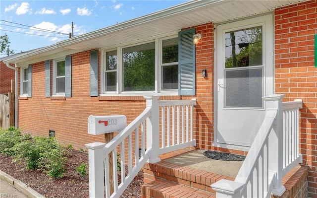 property entrance featuring brick siding