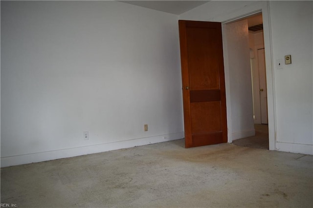unfurnished room featuring carpet floors and baseboards