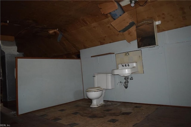 bathroom with toilet, vaulted ceiling, and wood finished floors