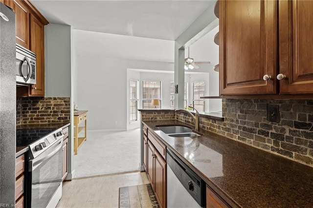 403 Harbour Pt Unit 305, Virginia Beach, VA 23451 - kitchen with ceiling fan, backsplash, appliances with stainless steel finishes, a sink, and dark stone counters