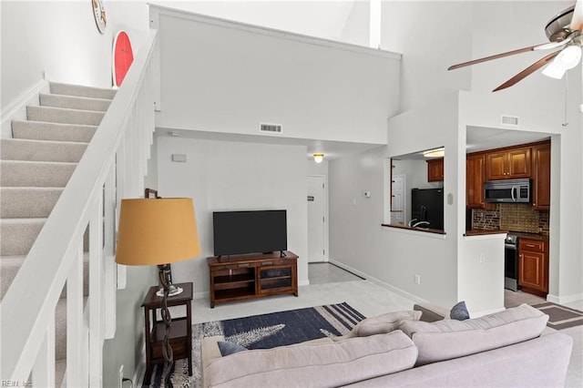403 Harbour Pt Unit 305, Virginia Beach, VA 23451 - living room with visible vents, ceiling fan, a high ceiling, and stairway