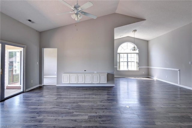 unfurnished living room with visible vents, dark wood-style flooring, lofted ceiling, baseboards, and ceiling fan