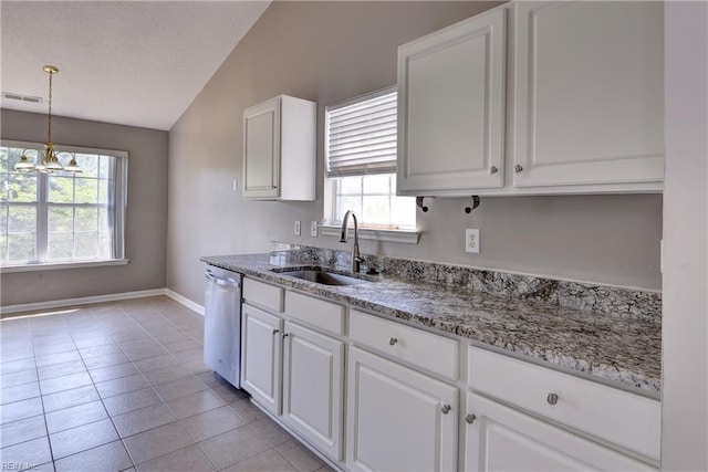 kitchen featuring stainless steel dishwasher, visible vents, white cabinetry, a sink, and vaulted ceiling