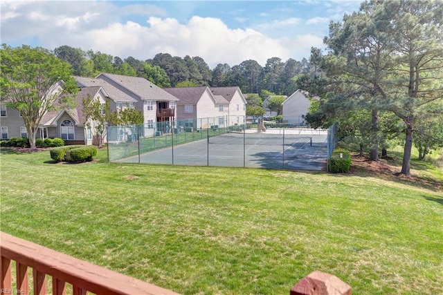 exterior space with a lawn, fence, and a residential view