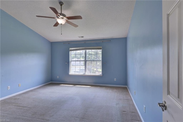 carpeted spare room featuring visible vents, a ceiling fan, a textured ceiling, and baseboards