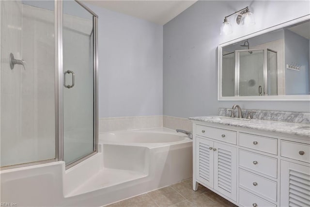 bathroom with a sink, double vanity, tile patterned floors, a garden tub, and a stall shower