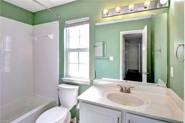 full bath with toilet, bathtub / shower combination, a wealth of natural light, and vanity