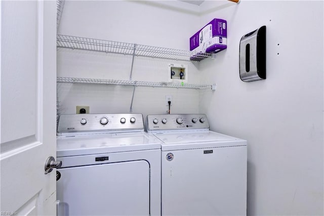 washroom with independent washer and dryer and laundry area