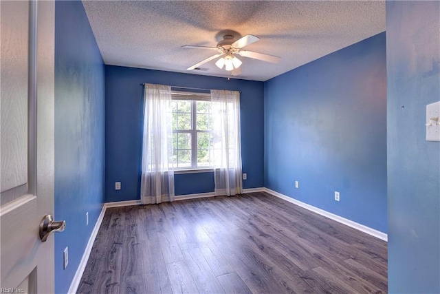 spare room featuring a textured ceiling, baseboards, a ceiling fan, and wood finished floors