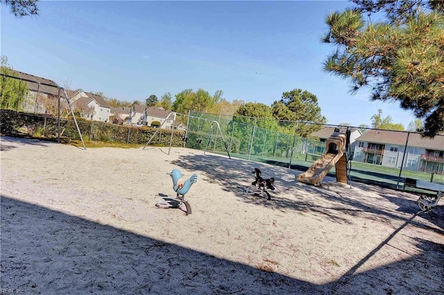 surrounding community featuring fence, a residential view, and playground community