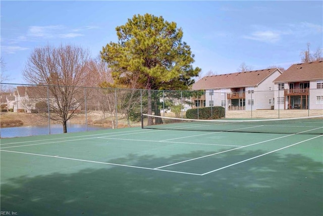 view of tennis court featuring fence and community basketball court