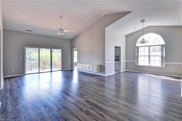 unfurnished living room featuring wood finished floors, ceiling fan, visible vents, and lofted ceiling