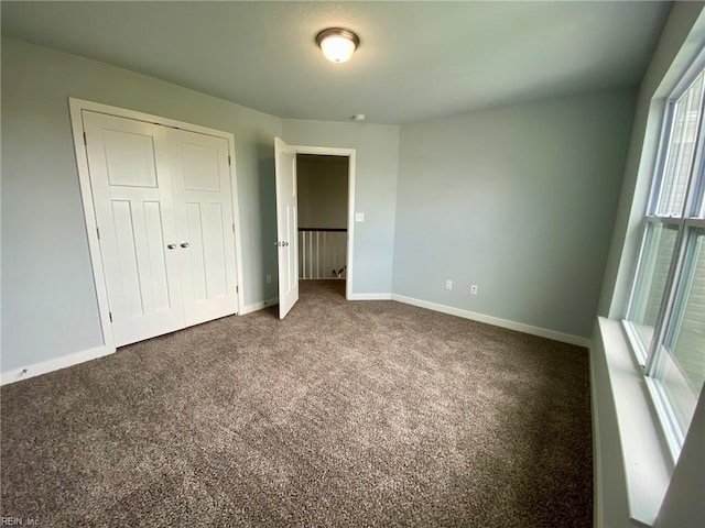 MM Savannah, Virginia Beach, VA 23456 - unfurnished bedroom featuring baseboards, a closet, and dark colored carpet