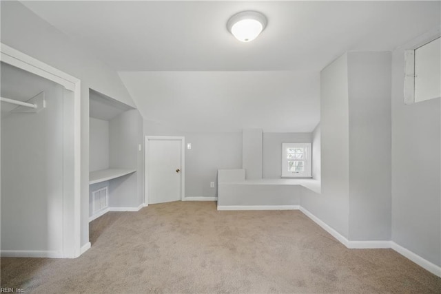 walk in closet featuring carpet and vaulted ceiling