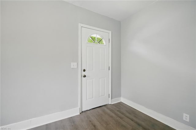 entryway featuring baseboards and dark wood-style floors