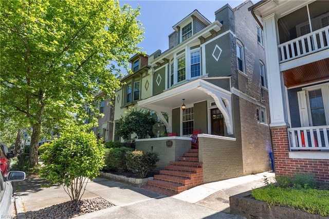 view of front of property with covered porch and brick siding