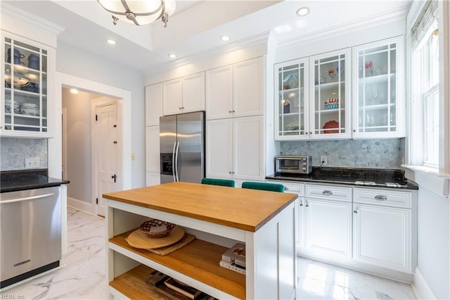 kitchen with open shelves, decorative backsplash, butcher block counters, white cabinets, and appliances with stainless steel finishes
