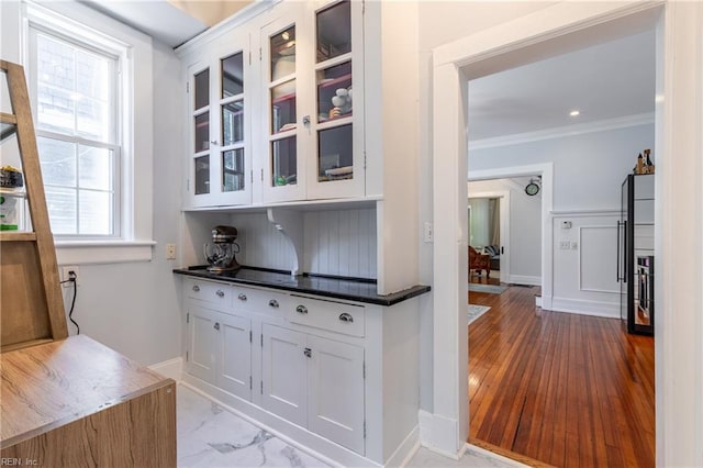 bar with crown molding and baseboards