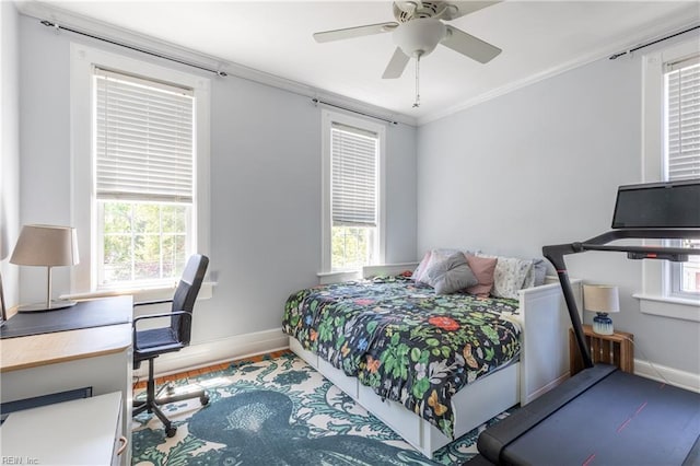 bedroom with baseboards, ornamental molding, ceiling fan, and wood finished floors