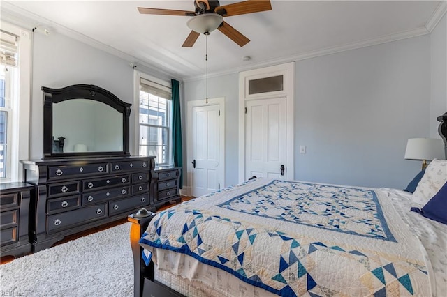 bedroom with ornamental molding, ceiling fan, and wood finished floors