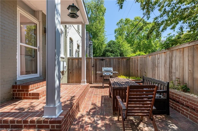 view of patio with a fenced backyard and grilling area
