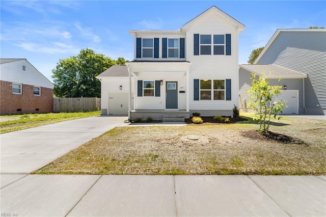 traditional-style home featuring fence, driveway, and a garage