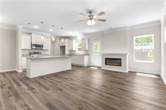 kitchen featuring crown molding, white cabinets, appliances with stainless steel finishes, and dark wood-type flooring