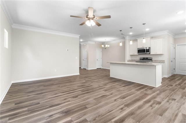 kitchen featuring appliances with stainless steel finishes, ceiling fan with notable chandelier, open floor plan, ornamental molding, and recessed lighting