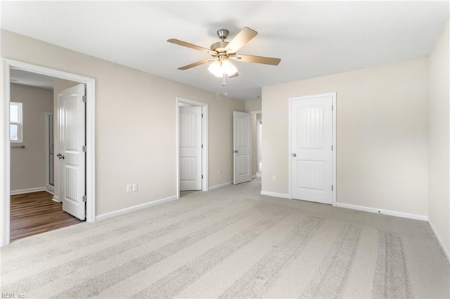 unfurnished bedroom with baseboards, carpet, and ensuite bath