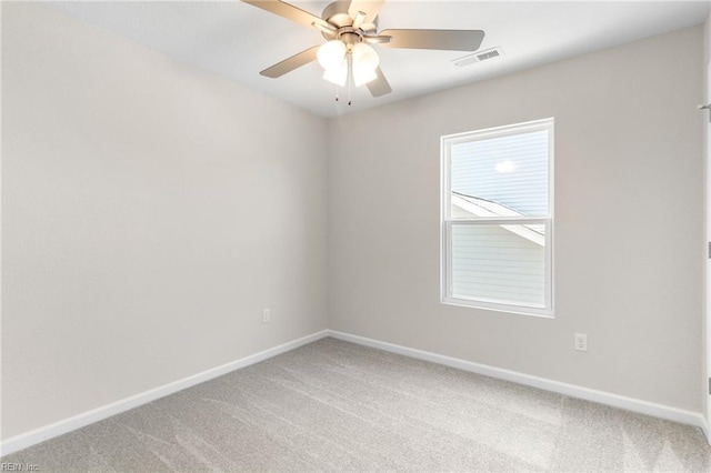 unfurnished room featuring baseboards, light carpet, a ceiling fan, and visible vents