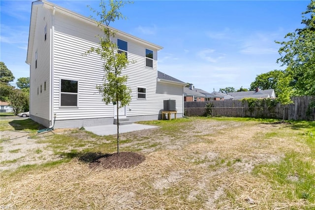 rear view of property with fence and cooling unit