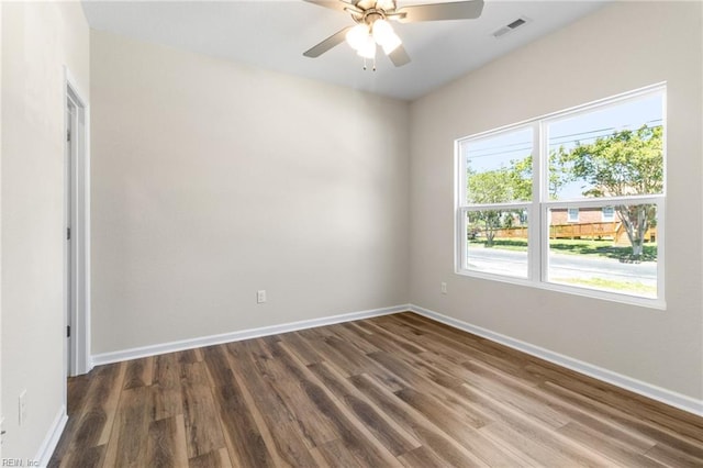 unfurnished room with visible vents, baseboards, and wood finished floors