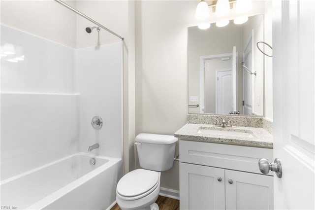 bathroom featuring toilet, tub / shower combination, and vanity