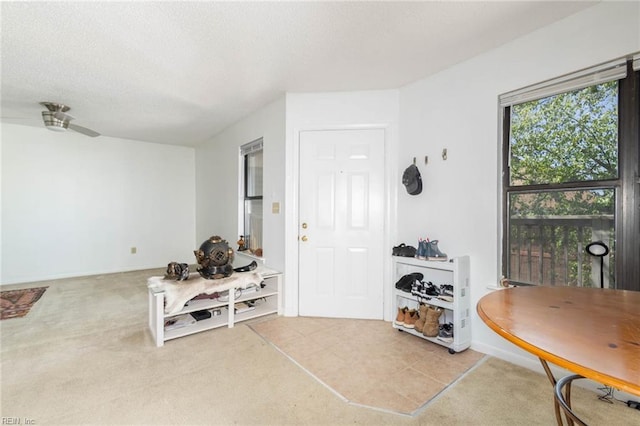 foyer entrance featuring a ceiling fan and a textured ceiling