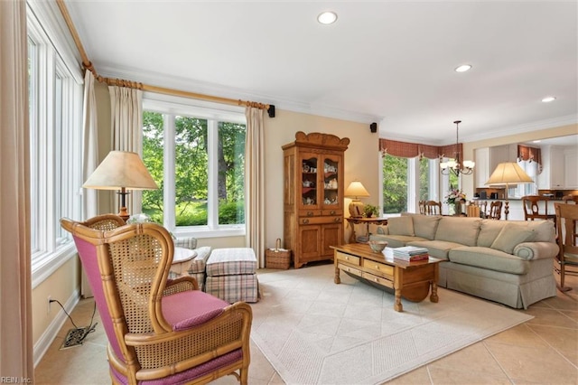 living area with light tile patterned floors, ornamental molding, recessed lighting, and a chandelier