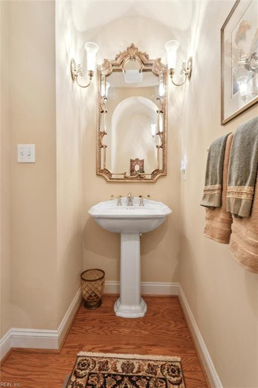 bathroom featuring baseboards and wood finished floors