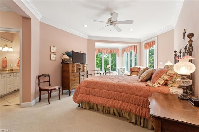 bedroom with crown molding, baseboards, light colored carpet, and connected bathroom