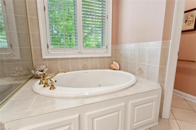 full bathroom with a jetted tub and tile patterned floors