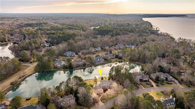 bird's eye view featuring a water view, a residential view, and a wooded view