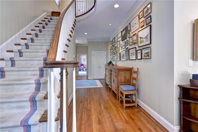 interior space with recessed lighting, baseboards, ornamental molding, and wood finished floors