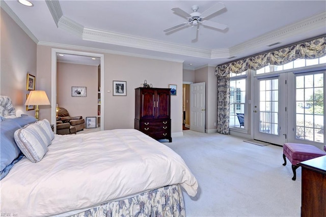 bedroom featuring crown molding, carpet flooring, a raised ceiling, and access to exterior