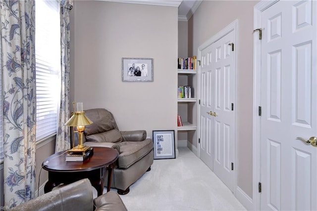 living area featuring carpet flooring, baseboards, and ornamental molding