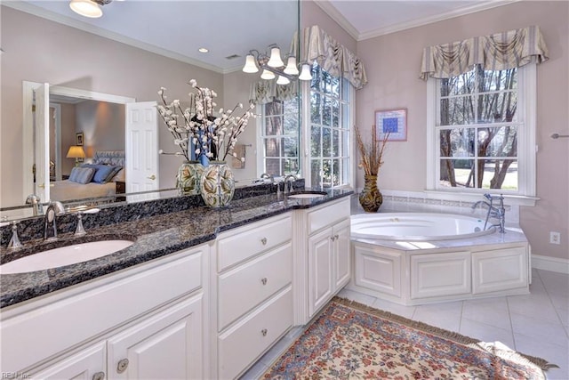 ensuite bathroom featuring a sink, tile patterned floors, ornamental molding, and a garden tub