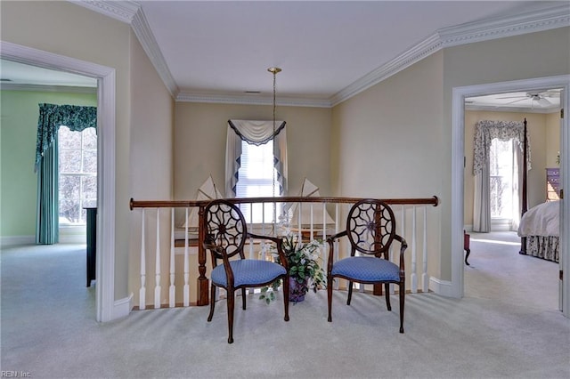 sitting room featuring a healthy amount of sunlight, carpet floors, and ornamental molding
